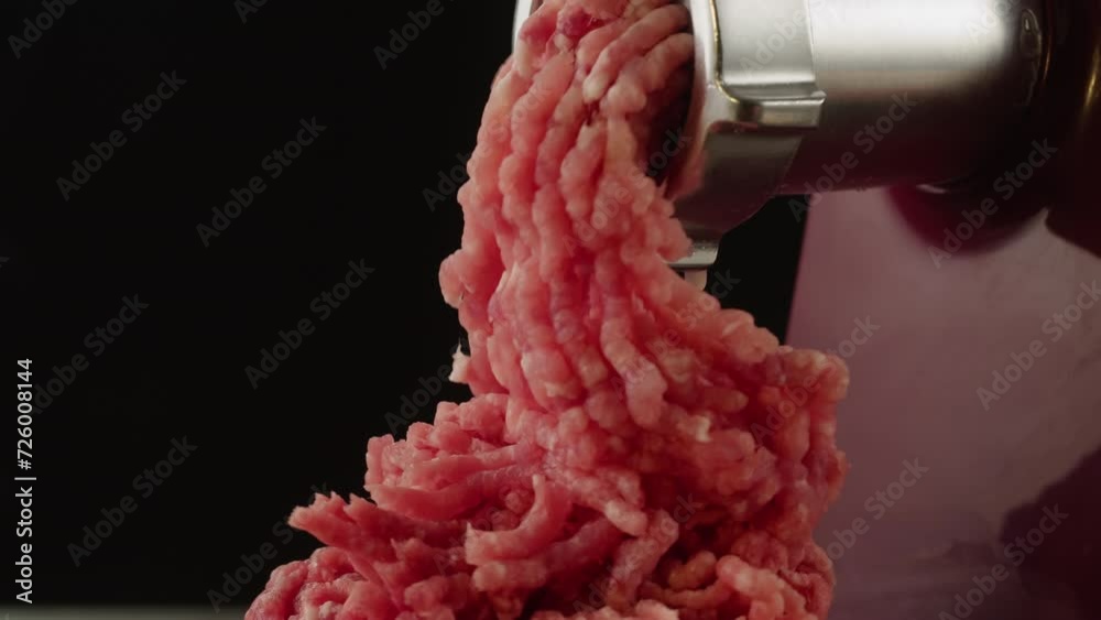 Twist a meat or pork fart in a meat grinder closeup macro. Mince