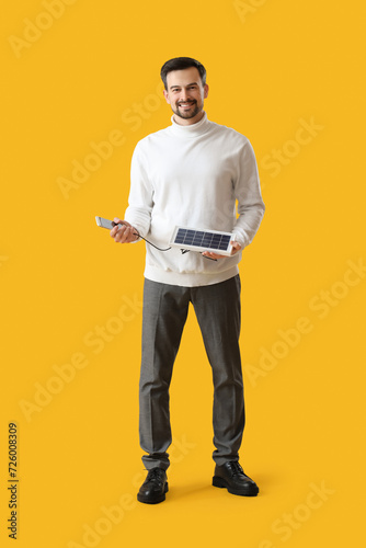 Handsome man with portable ...