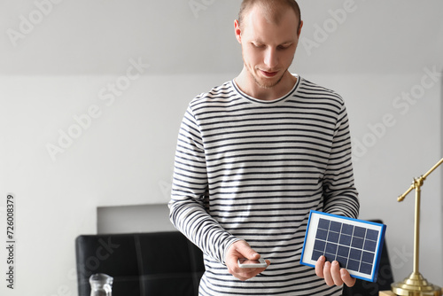 Young man using mobile phon...