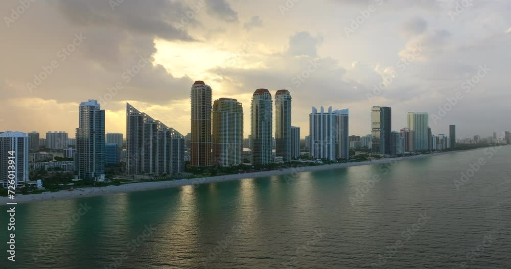 High angle view of Sunny Isles Beach city with waterfront highrise hotels and condo buildings on Atlantic ocean shore. American tourism infrastructure in coastal southern Florida High angle view of Sunny Isles Beach city with waterfront highrise hotels and condo buildings on Atlantic ocean shore. American tourism infrastructure in coastal southern Florida