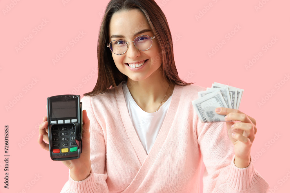 Female seller with money and payment terminal on pink background, closeup Female seller with money and payment terminal on pink background, closeup