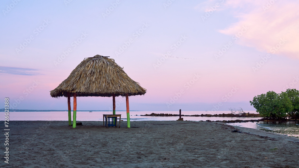 Fototapeta premium Palapas or huts built on the beaches of the Colombian Caribbean region used as shelter from the sun or rain and for eating and resting.