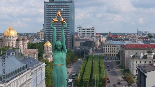Beautiful sunrise view over Riga by the statue of liberty - Milda in Latvia. The monument of freedom.