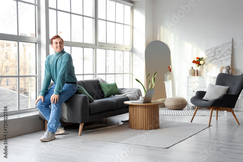 Young man sitting on soft s...
