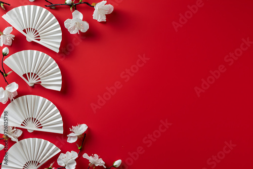 Festival paper fans and blossom flowers on red background. Happy Chinese New Year. Spring floral banner in traditional japanese style