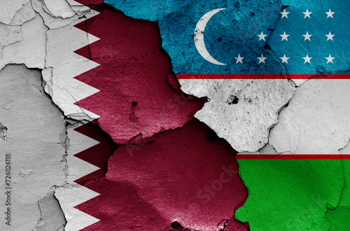 flags of Qatar and Uzbekistan painted on cracked wall