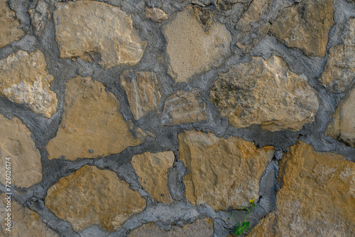 wall made of real stone as a background in the sun 10