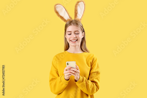 Young woman in bunny ears u...