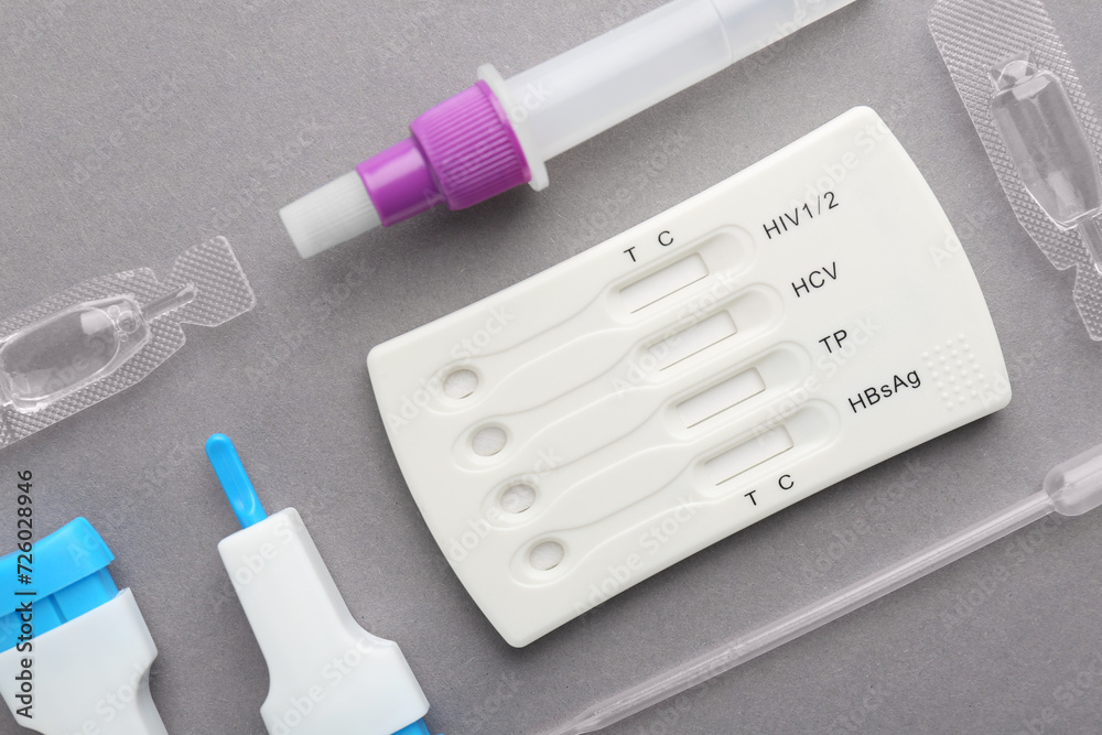 Disposable multi-infection express test kit on grey background, flat lay Disposable multi-infection express test kit on grey background, flat lay