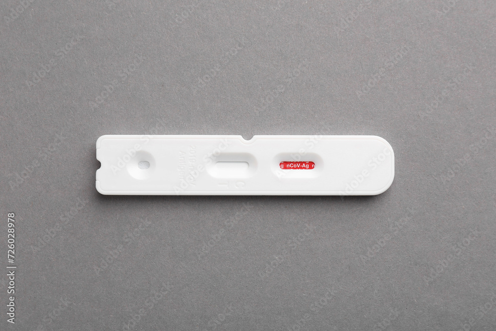 Disposable Covid-19 express test on grey background, top view Disposable Covid-19 express test on grey background, top view