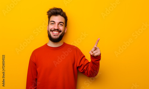 man pointing to something on a yellow background