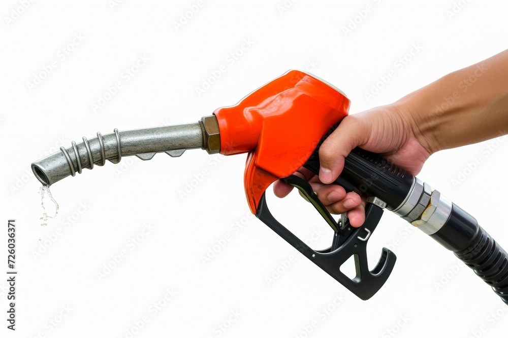 Hand with fuel gun and pouring gasoline or diesel. Backdrop with selective focus and copy space Hand with fuel gun and pouring gasoline or diesel. Backdrop with selective focus and copy space