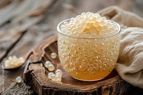 Pearl topping made from tapioca used in tea or beverages in a cup on wooden table