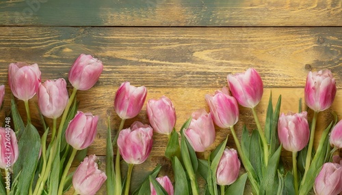 tulips on wooden table  Tulip border with copy space. Beautiful frame of spring flowers. Bouquet of pink tulips flowers on yellow vintage wooden background  wallpaper