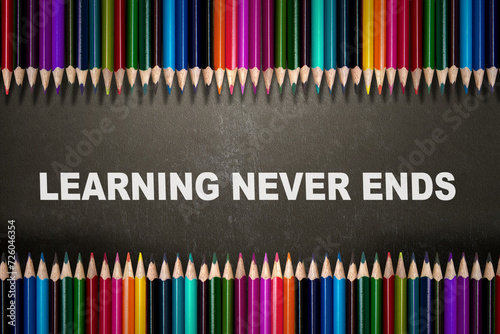 A row of colored pencils with the text of learning never ends