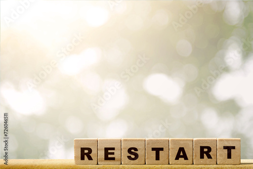 A row of wooden cubes with restart text photo