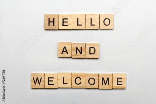 A row of wooden cubes with hello and welcome text