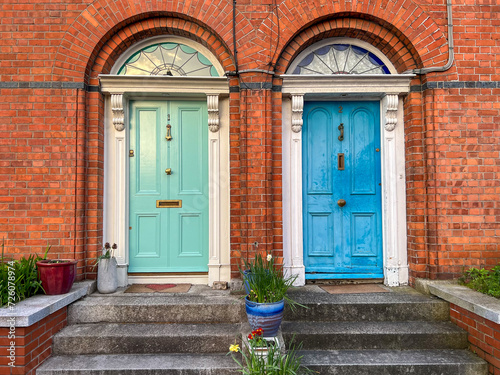Colorful green and blue doors in red brick wall with stairs, Dalkey, Ireland 