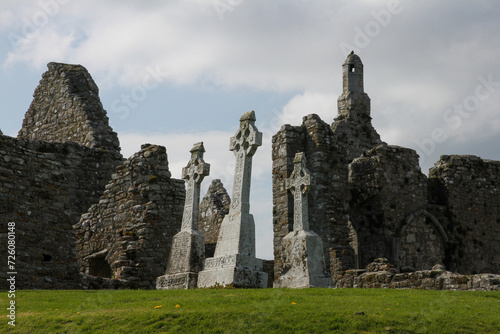 Celtic crosses in field with ruined buildings, Clonmacnoise, Ireland