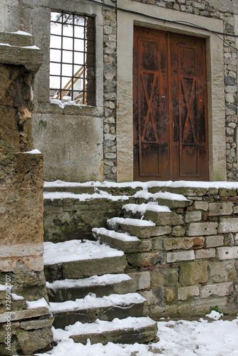 Antique door and stone wall and stairs in the snow, Topkapi Palace, Istanbul, Turkey 