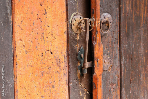 Close up of wooden door and antique metal door latch in Topkapi Palace, Istanbul, Turkey 