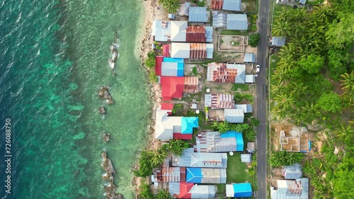 Gorontalo, Indonesia: Top down aerial drone footage of the coastal road in Gorontalo by the Celebes sea in the Sulawesi island in Indonesia photo