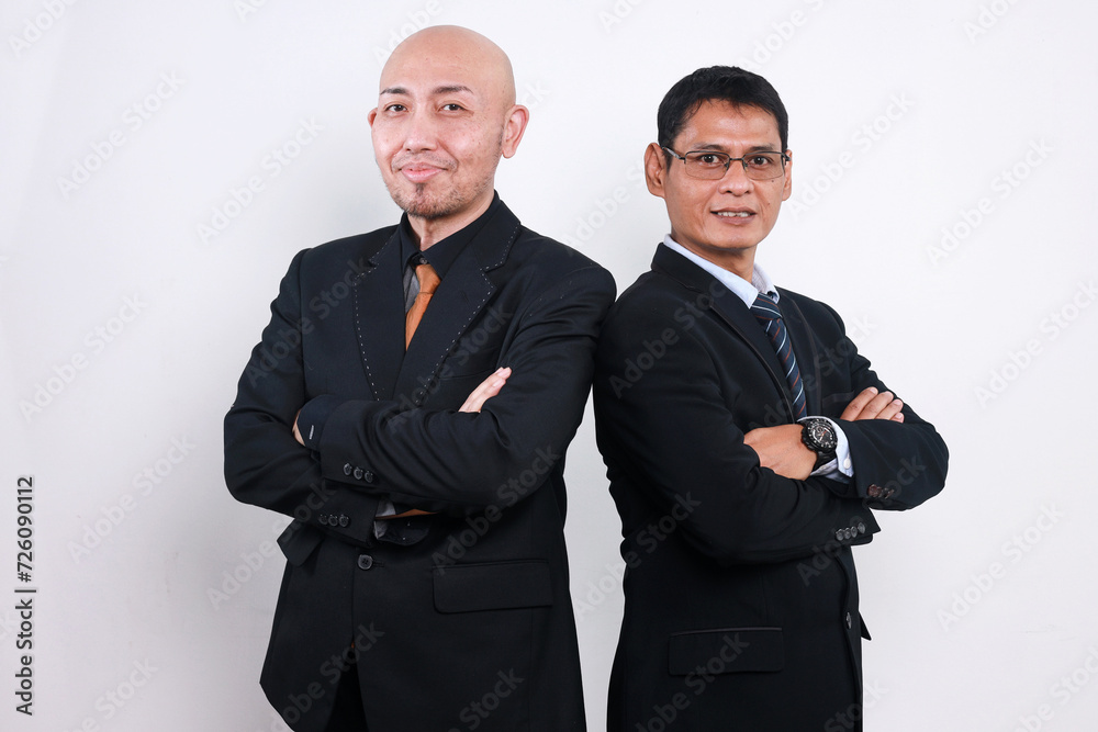 Two Asian business partners standing together in white background Two Asian business partners standing together in white background