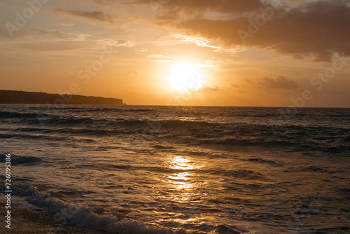 Warm sunset over the ocean view from the beach. Beautiful sun over the sea