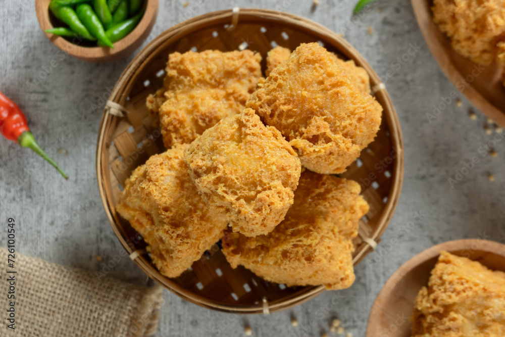 Tahu goreng cripsy, or crispy fried tofu, is one type of snack in Indonesia. Crispy tofu is mixed with small chilies and sauce Tahu goreng cripsy, or crispy fried tofu, is one type of snack in Indonesia. Crispy tofu is mixed with small chilies and sauce