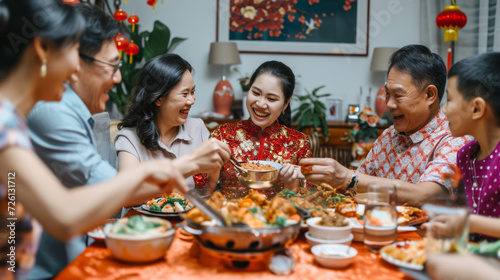 Group of multi generation Chinese family have dinner together on Chinese new year day. Chinese family visiting grandparent gather together have meal and celebrate Chinese new year.