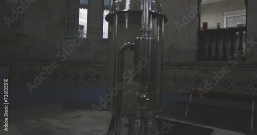 Clear glass water tank container with bubbles. Industrial mineral filtration system station plant.  photo
