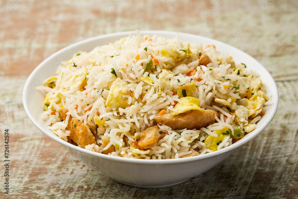 Mixed fried rice include egg, chicken, shrimp and prawn served in dish isolated on table top view of arabic food Mixed fried rice include egg, chicken, shrimp and prawn served in dish isolated on table top view of arabic food