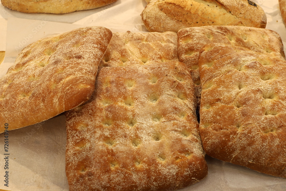 Bread and bakery products lie on display in a store. Bread and bakery products lie on display in a store.