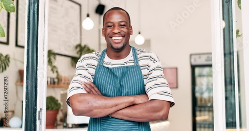 Smile, arms crossed and black man at entrance to coffee shop for small business opening or welcome. Portrait, retail and service with happy startup cafe owner or entrepreneur at door of restaurant photo
