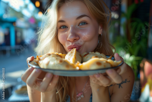 Photo of attractive blonde woman with love to food polish pierogi