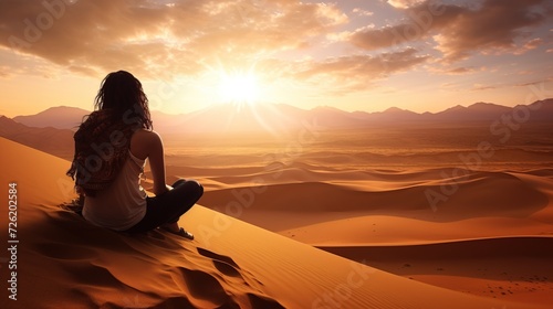 Sexy woman walking in the desert.Beautiful view on the mountain at sunset. Amazing sand dunes. Golden sand waves. Natural safari panorama. Unique journey. photo