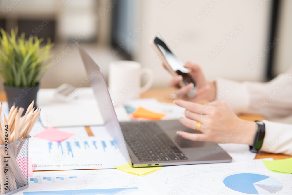 Fototapeta premium Asian businesswoman holding notebook about business, spending money