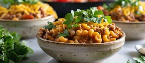 Serving homemade hamburger helper in ceramic bowls.