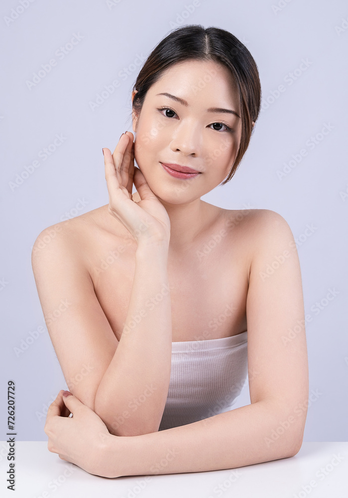 Closeup portrait of beauty asian woman with fair perfect healthy glow skin hand touching cheek isolated on white, young beautiful asia girl with pretty smile on face. Beauty korean spa skincare banner Closeup portrait of beauty asian woman with fair perfect healthy glow skin hand touching cheek isolated on white, young beautiful asia girl with pretty smile on face. Beauty korean spa skincare banner