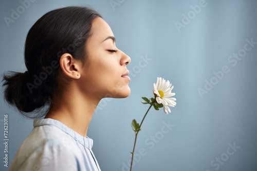 profile of girl smelling bloom photo