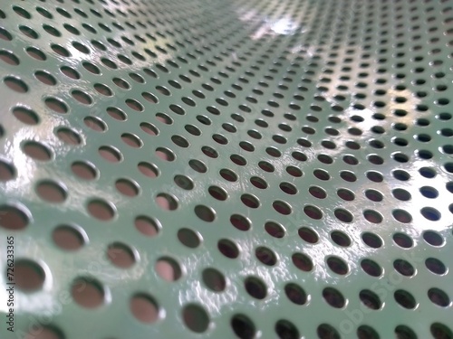 Perforated pattern on white colored iron plate	