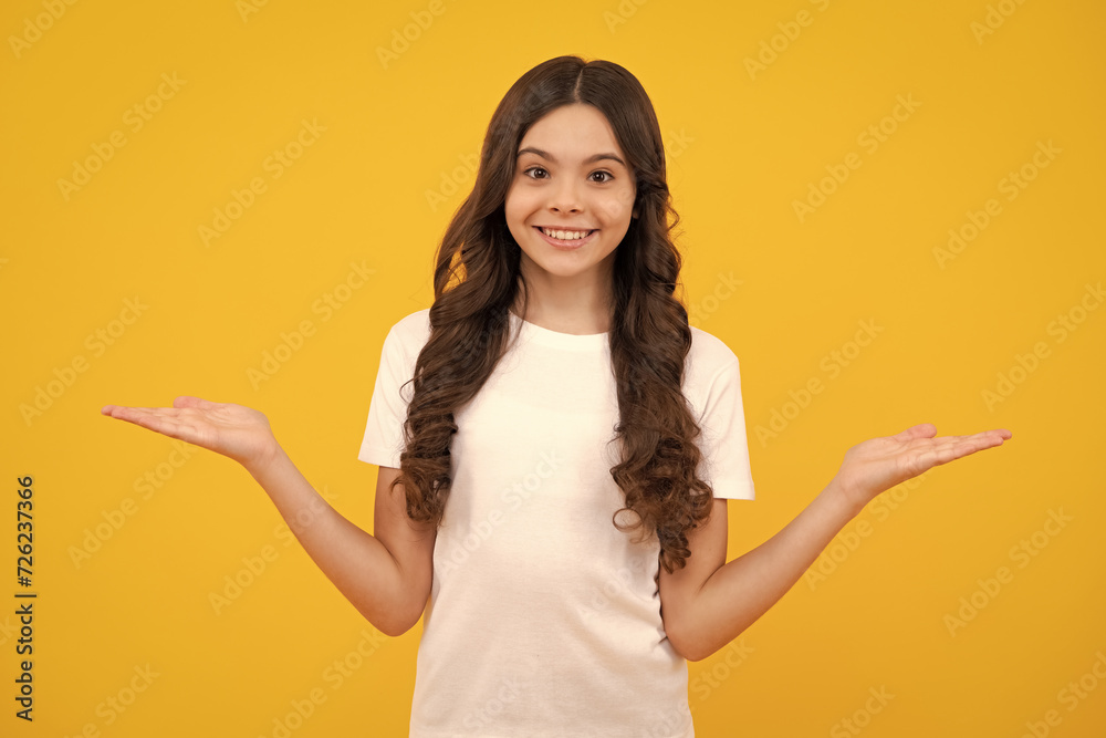 Wow, it's unbelievable. Shocked teenager child pointing aside at copy space. Teen girl pointing with two hands and fingers to the side. Happy teenager, positive and smiling emotions of teen girl. Wow, it's unbelievable. Shocked teenager child pointing aside at copy space. Teen girl pointing with two hands and fingers to the side. Happy teenager, positive and smiling emotions of teen girl.