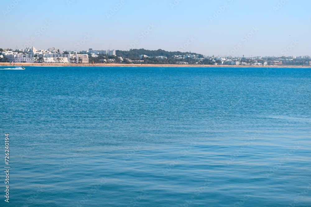 Panorama landscape view of blue sea water with city buildings