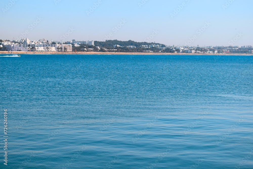 Panorama landscape view of blue sea water with city buildings Panorama landscape view of blue sea water with city buildings