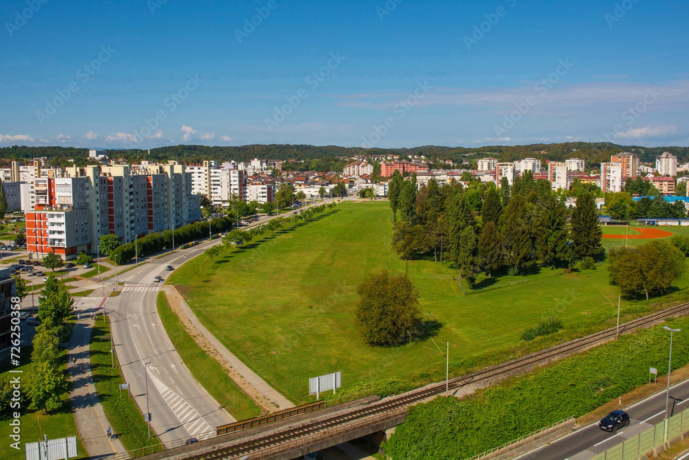 An aerial view over a residential area of Karlovac, south of the historic centre, in Central Croatia. A baseball field is foreground right