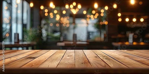 Vintage wooden table with blurred bokeh background in modern cafe or restaurant abstract perfect for displaying products with bright light retro design and empty space for business or celebration