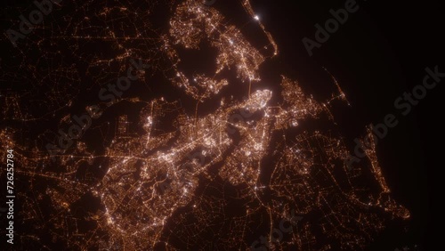 Charleston (South Carolina, USA) aerial view at night. Top view on modern city with street lights. Camera is zooming out, rotating counterclockwise. Vertical video. The north is on the left side photo