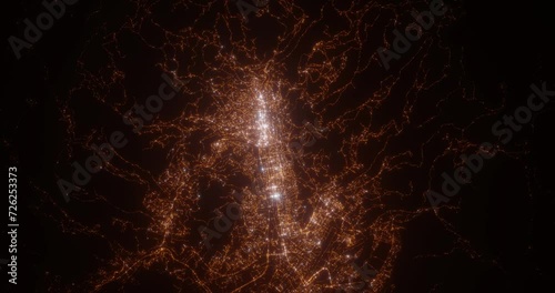 Sarajevo (Bosnia and Herzegovina) top view at night. Top view on modern city with street lights and glow effect. Camera is zooming in, rotating clockwise. Vertical video. The north is on the left side photo