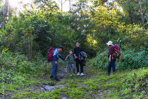 Group of Asian hikers trekking in the woods