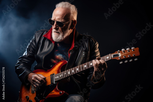 Cool grandpa wearing a leather jacket and ripped jeans  casually playing an electric guitar